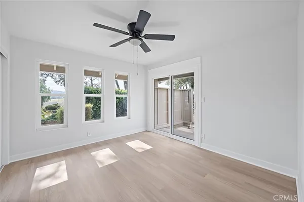 a view of a livingroom with a ceiling fan and window