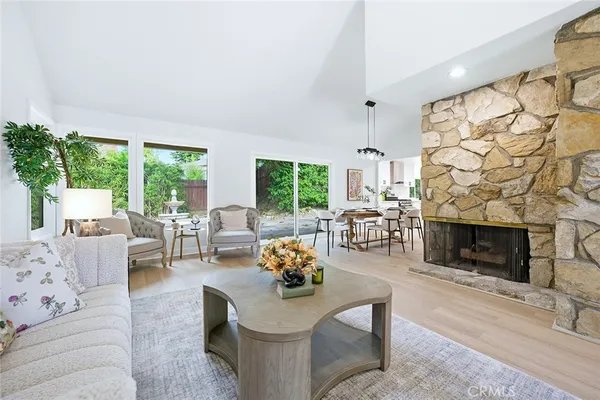 a living room with furniture fireplace and flat screen tv