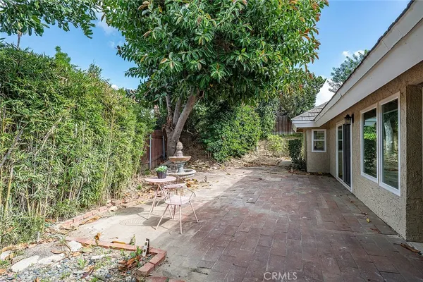 a view of a house with a tree in the background