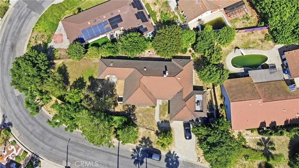 an aerial view of a house with a garden and swimming pool