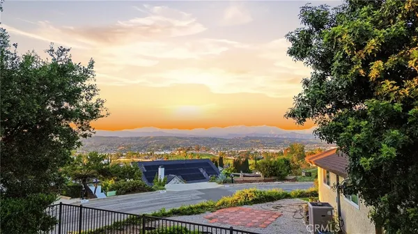 an aerial view of residential houses and trees in the background