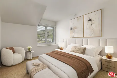 a bedroom with bed and a couch