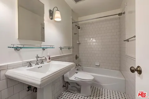 a bathroom with a sink toilet a shower and a mirror