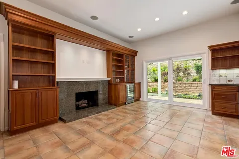 a view of empty room with fireplace and fan