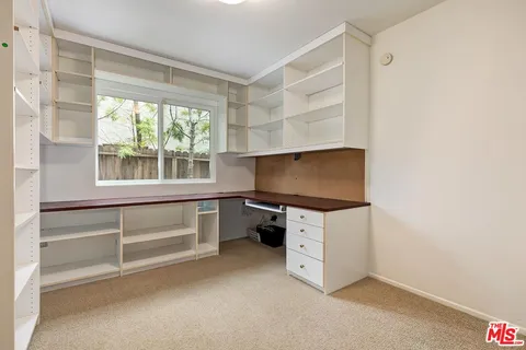 a kitchen with white cabinets and a stove top oven