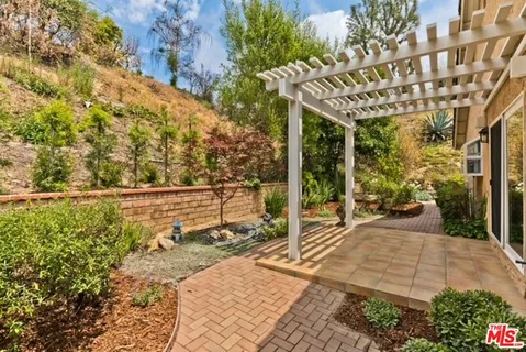 a view of a patio with table and chairs and potted plants