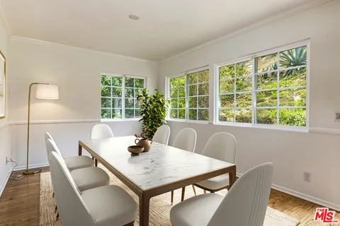 a view of a dining room with furniture window and outside view
