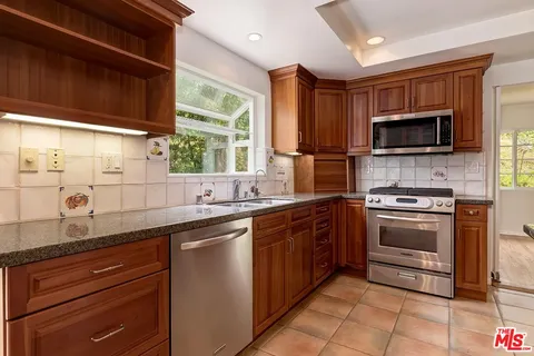 a kitchen with a sink stove and microwave