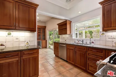 a kitchen with stainless steel appliances granite countertop a sink and cabinets