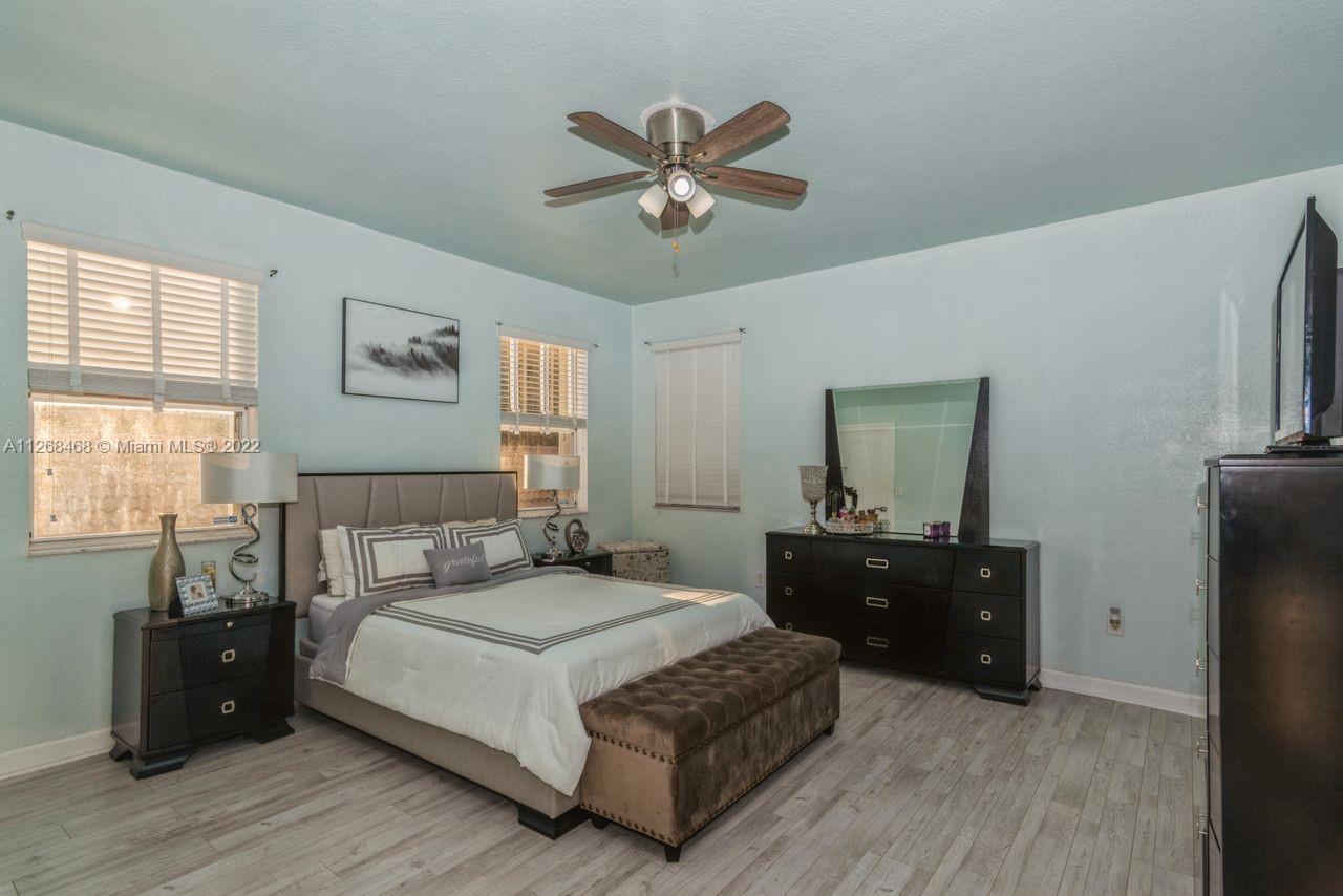 2240 Northeast 37th Terrace Homestead, FL 33033 - Photo 11 of 18 a bedroom with a bed and wooden floor