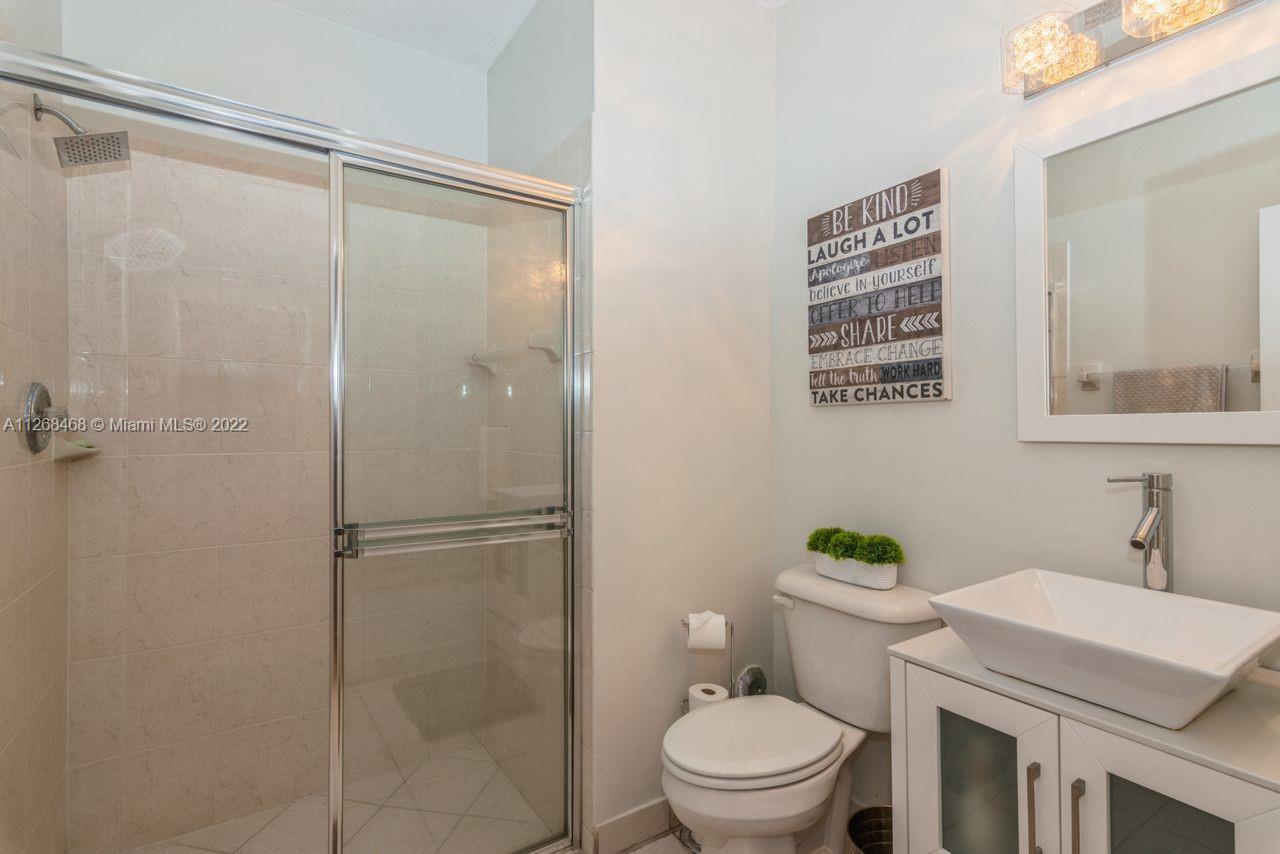 2240 Northeast 37th Terrace Homestead, FL 33033 - Photo 15 of 18 a bathroom with a shower a toilet and a sink