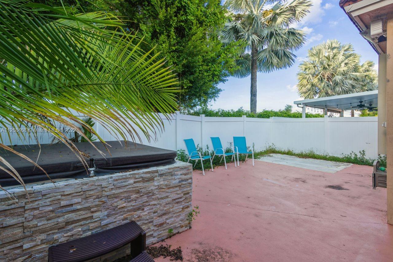 2240 Northeast 37th Terrace Homestead, FL 33033 - Photo 18 of 18 a backyard of a house with table and chairs