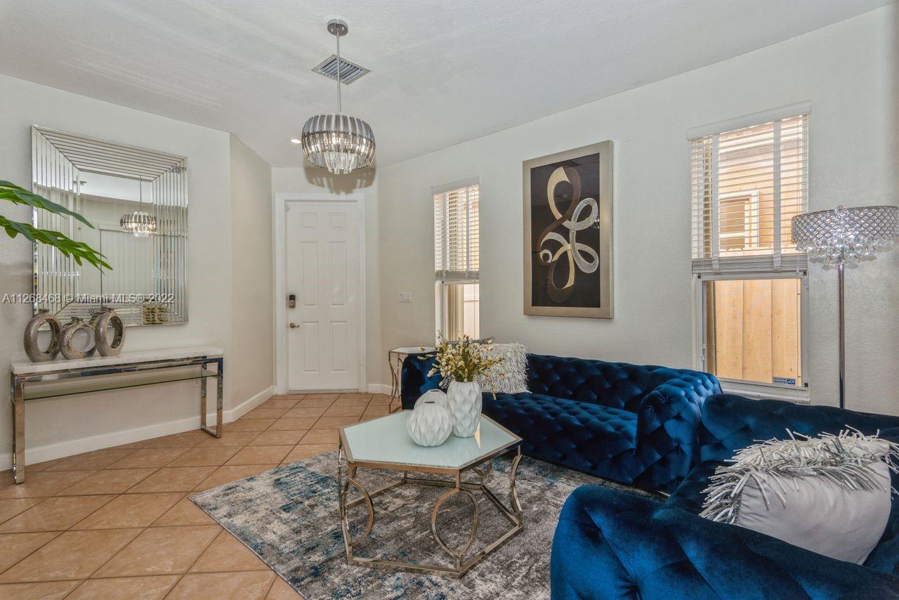 2240 Northeast 37th Terrace Homestead, FL 33033 - Photo 3 of 18 a living room with furniture and a chandelier