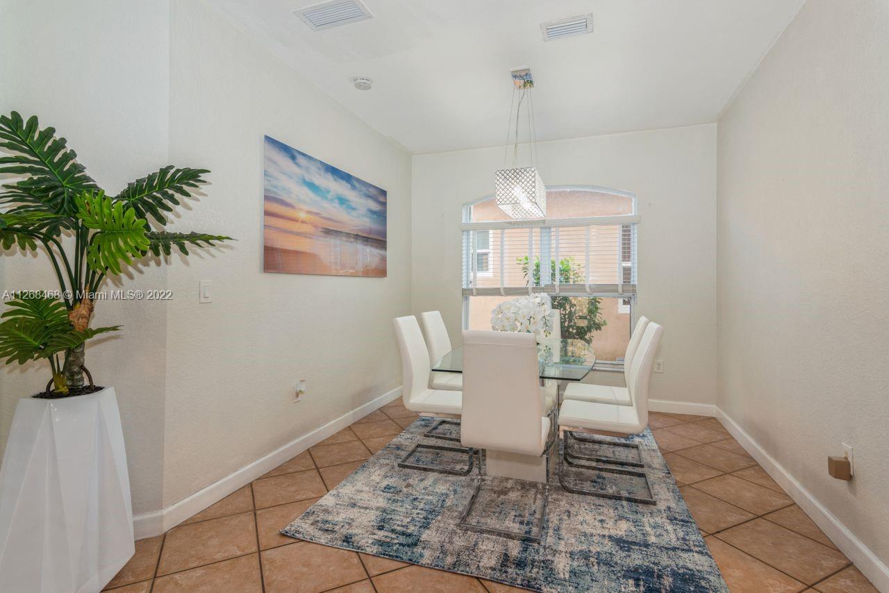 2240 Northeast 37th Terrace Homestead, FL 33033 - Photo 8 of 18 a view of a dining room with furniture window and wooden floor