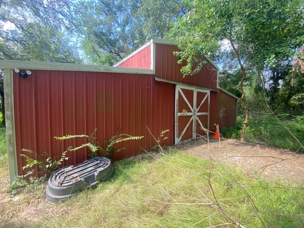 a backyard of a house with table and chairs