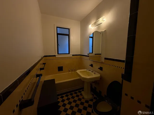 a bathroom with a sink toilet and mirror