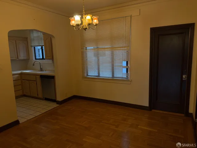 a view of livingroom with chandelier fan and windows