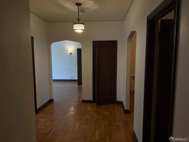 a view of a room with wooden floor