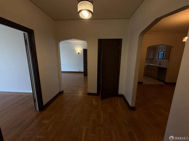 a view of a hallway with wooden floor
