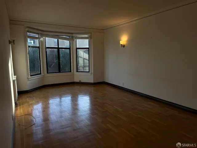 a view of wooden floor and windows in a room