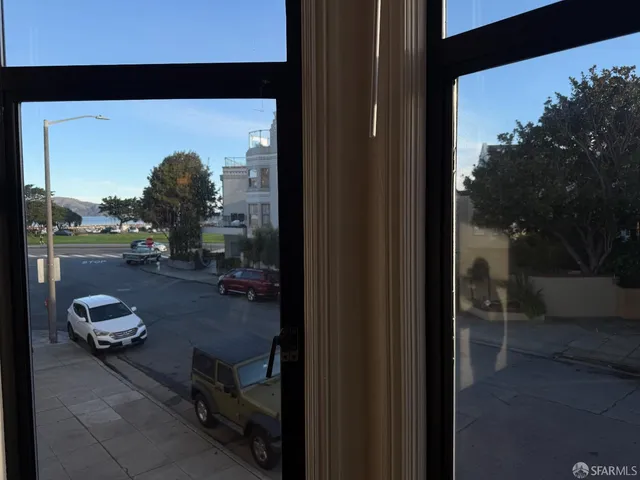 a living room with furniture and a floor to ceiling window