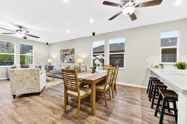 a living room with furniture a window and wooden floor
