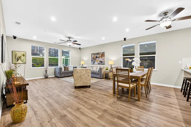 a living room with furniture and wooden floor