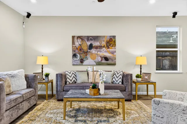 a living room with furniture and kitchen view