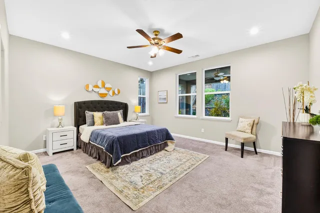 a bedroom with a bed and ceiling fan