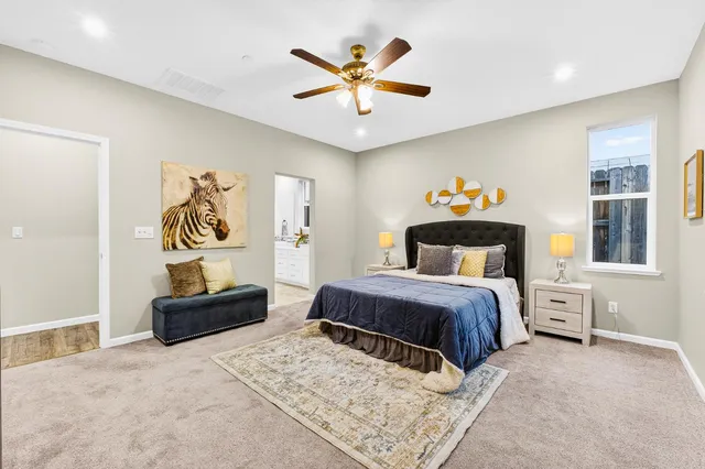 a bedroom with a bed and a chandelier