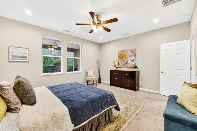 a bedroom with a bed and a couch