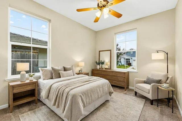 an empty room with a ceiling fan and carpet