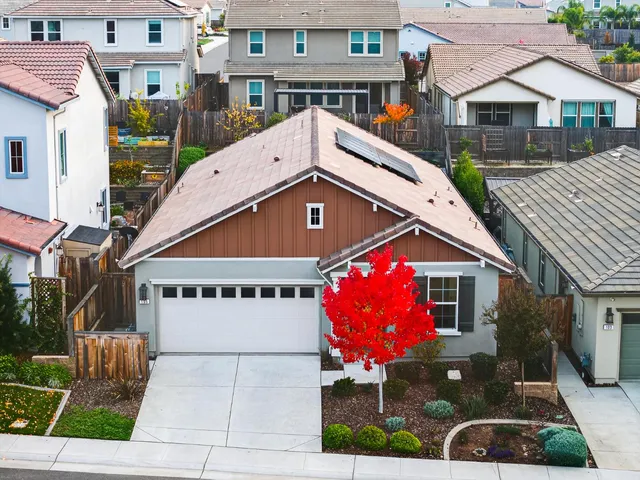 an aerial view of a city with lots of buildings and ocean view
