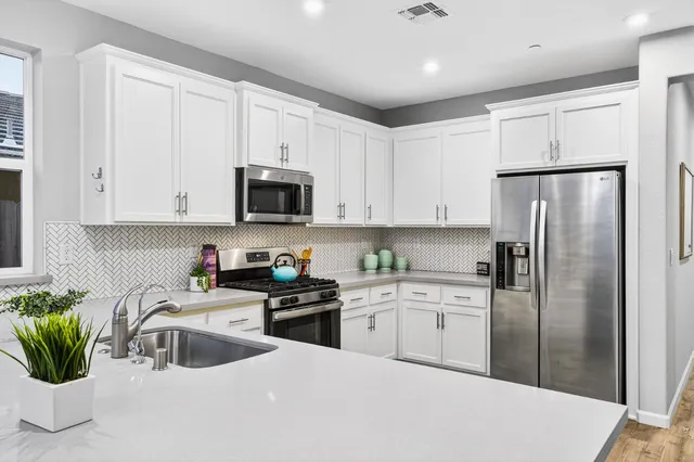 a kitchen with a sink stove and cabinets