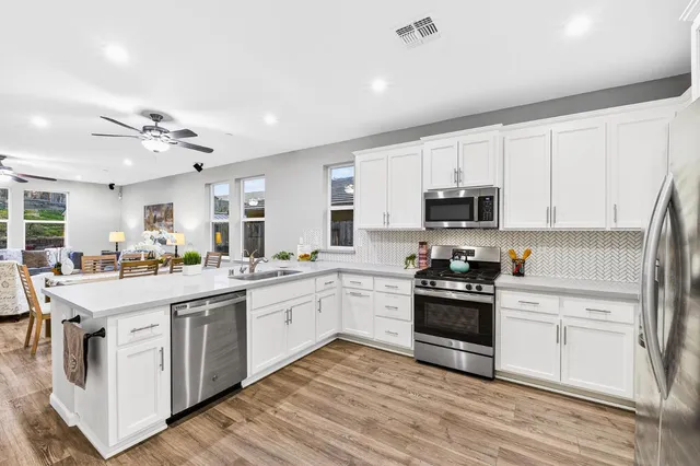 a kitchen with sink cabinets and wooden floor