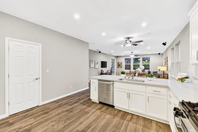 a kitchen with a stove top oven a sink and a refrigerator