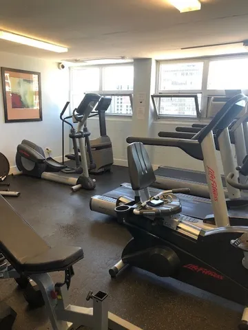 a street sign that is sitting on a wooden fence