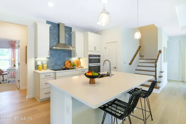 a kitchen with a table chairs and a stove