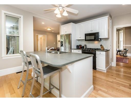 19 Forest Street Newton, MA 02461 - Photo 12 of 33 a kitchen with stainless steel appliances granite countertop a stove top oven a sink a dining table and chairs