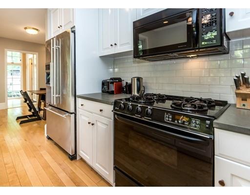19 Forest Street Newton, MA 02461 - Photo 15 of 33 a kitchen with stainless steel appliances a stove a microwave and cabinets