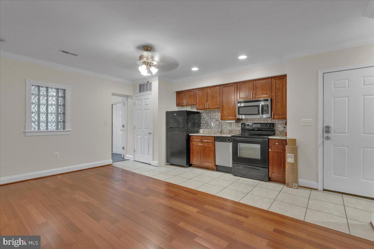 1707 Capitol Avenue Northeast, Unit 3 Washington, DC 20002 - Photo 3 of 11 a kitchen with stainless steel appliances granite countertop a refrigerator and a stove top oven