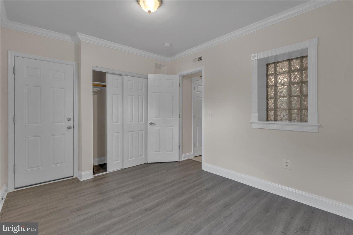 1707 Capitol Avenue Northeast, Unit 3 Washington, DC 20002 - Photo 8 of 11 a view of an empty room with wooden floor and a window