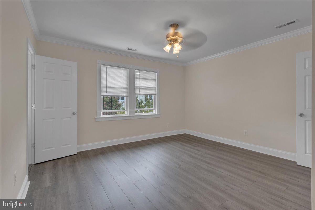 1707 Capitol Avenue Northeast, Unit 3 Washington, DC 20002 - Photo 9 of 11 a view of an empty room with a window and wooden floor