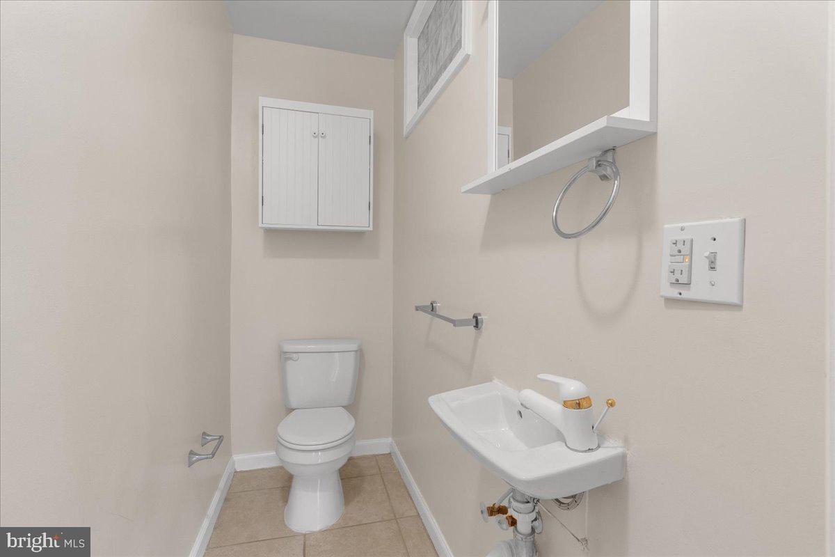 1707 Capitol Avenue Northeast, Unit 3 Washington, DC 20002 - Photo 10 of 11 a bathroom with a toilet a sink and mirror