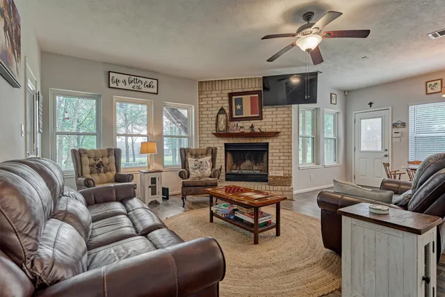 a living room with furniture fireplace and a large window