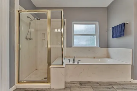 a bathroom with a bathtub and a shower