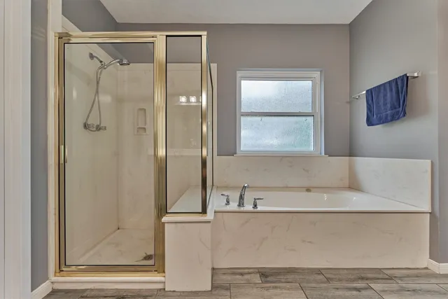 a bathroom with a bathtub and a shower