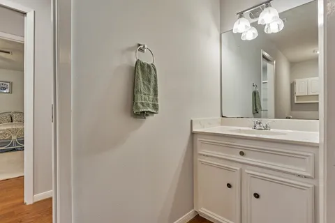 a bathroom with a sink vanity and a mirror