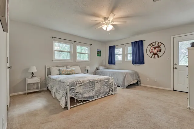 a spacious bedroom with a bed and window
