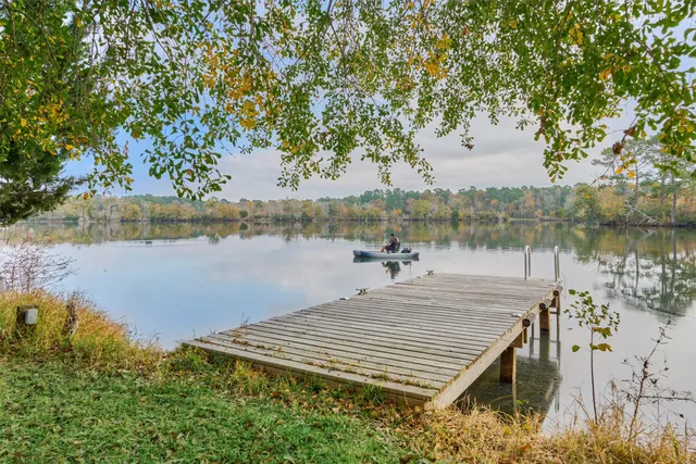 a view of a lake with chairs